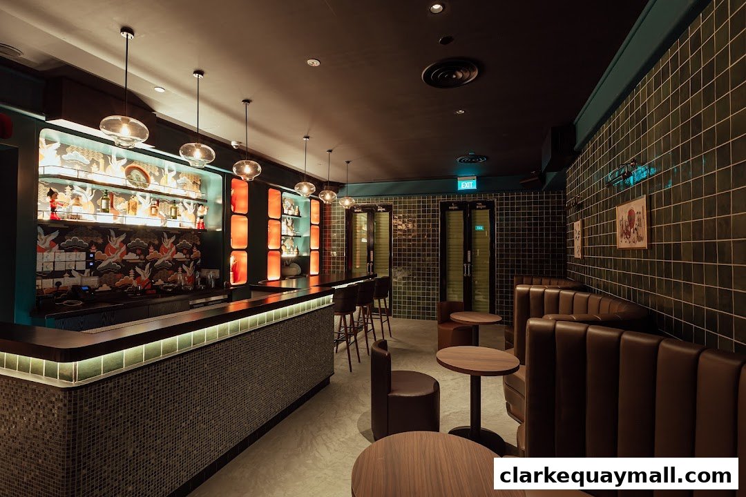 Interior of a stylish cocktail lounge with a long bar, booth seating, and decorative shelving.