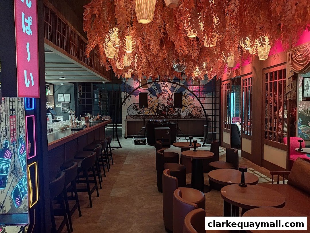 Interior of a stylish cocktail lounge with a bar, seating, and unique Japanese-inspired decor.