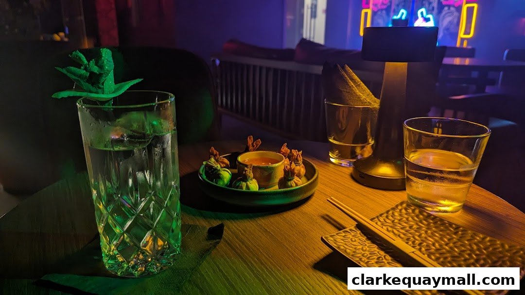 A table at a speakeasy cocktail lounge with drinks and appetizers.