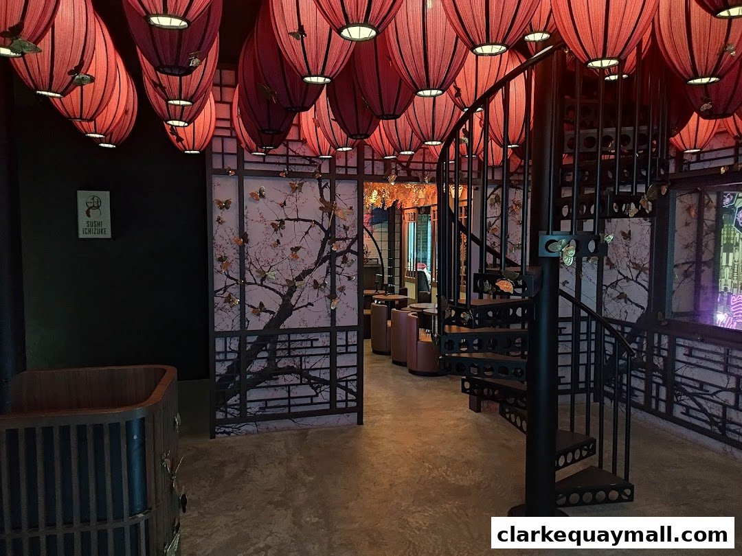 Interior of a cocktail lounge with red lanterns, a spiral staircase, and decorative screens.