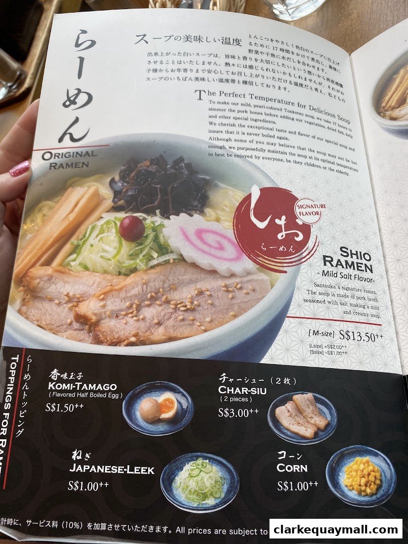 A menu page showcasing a bowl of ramen and various toppings with prices.