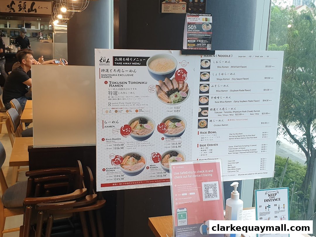 A menu board for Hokkaido Ramen Santouka, featuring various ramen dishes and side orders.