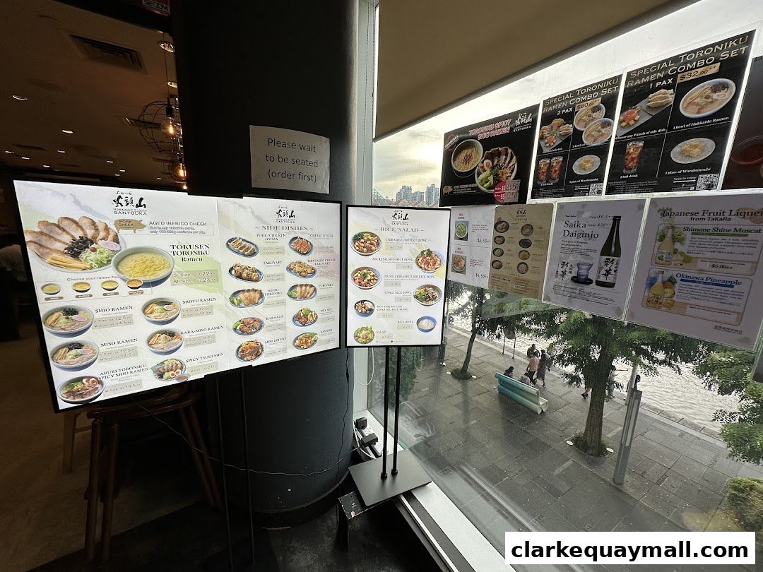 Digital menus displaying ramen, side dishes, and drinks at Hokkaido Ramen Santouka.