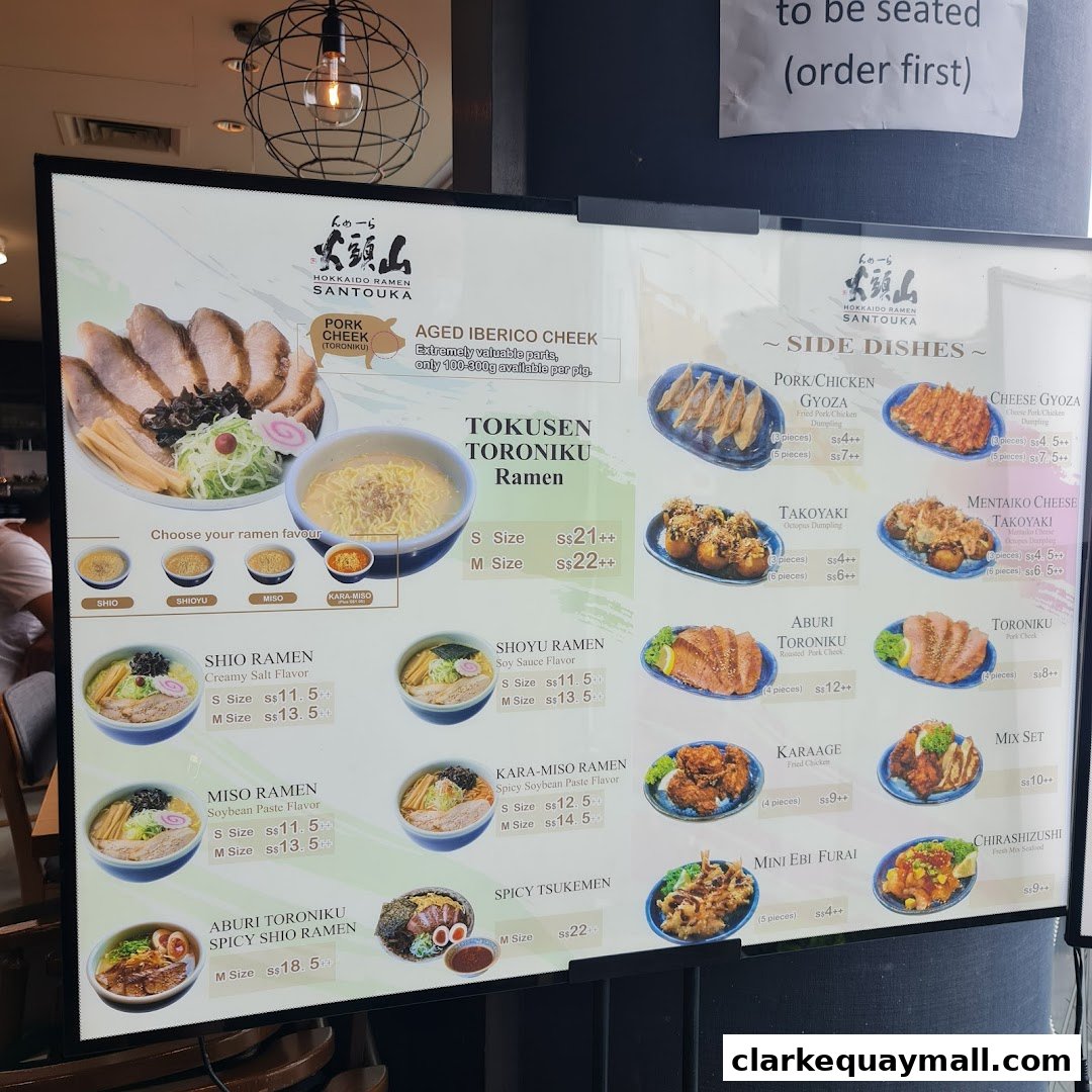 A digital menu board displaying various ramen dishes and side dishes from Hokkaido Ramen Santouka.