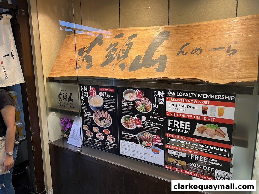 Hokkaido Ramen Santouka menu board featuring ramen dishes and loyalty program details.