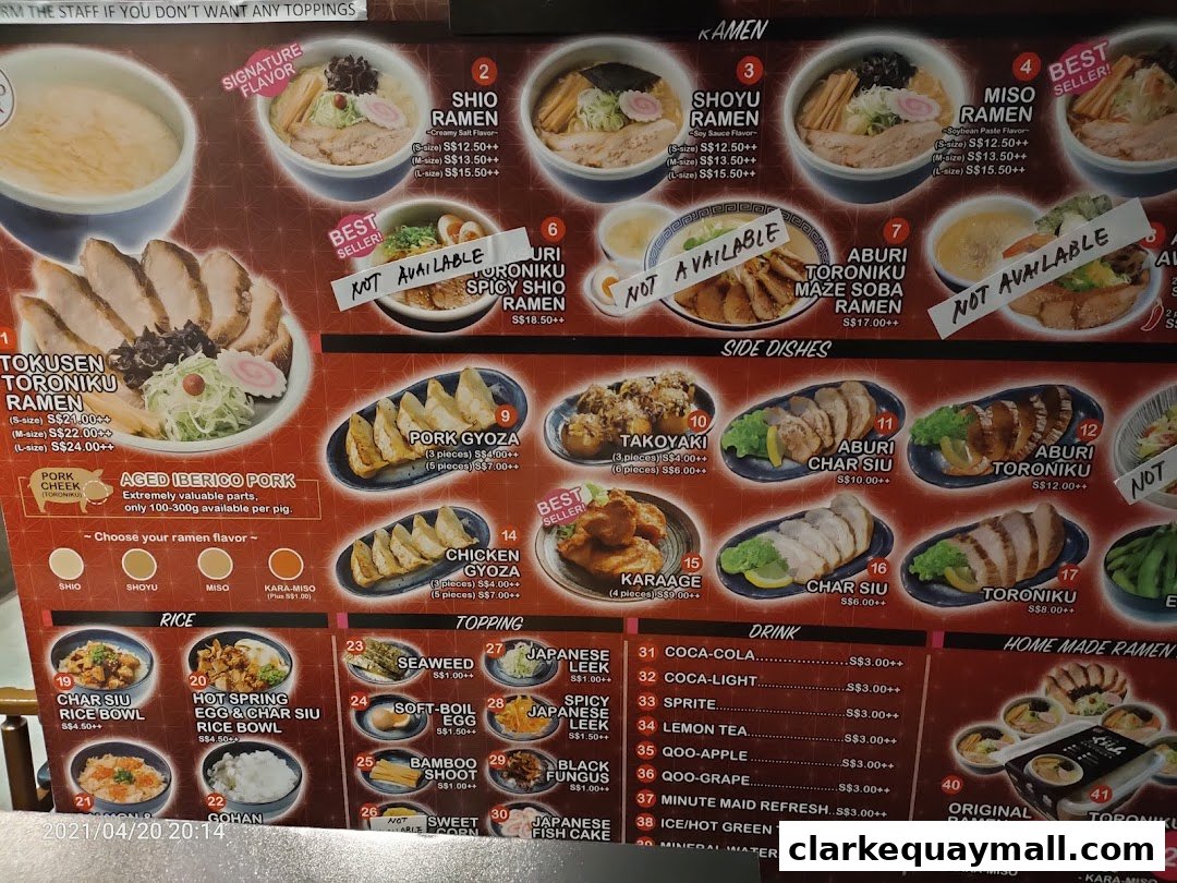A menu board displaying various ramen dishes, side dishes, rice bowls, drinks, and toppings.
