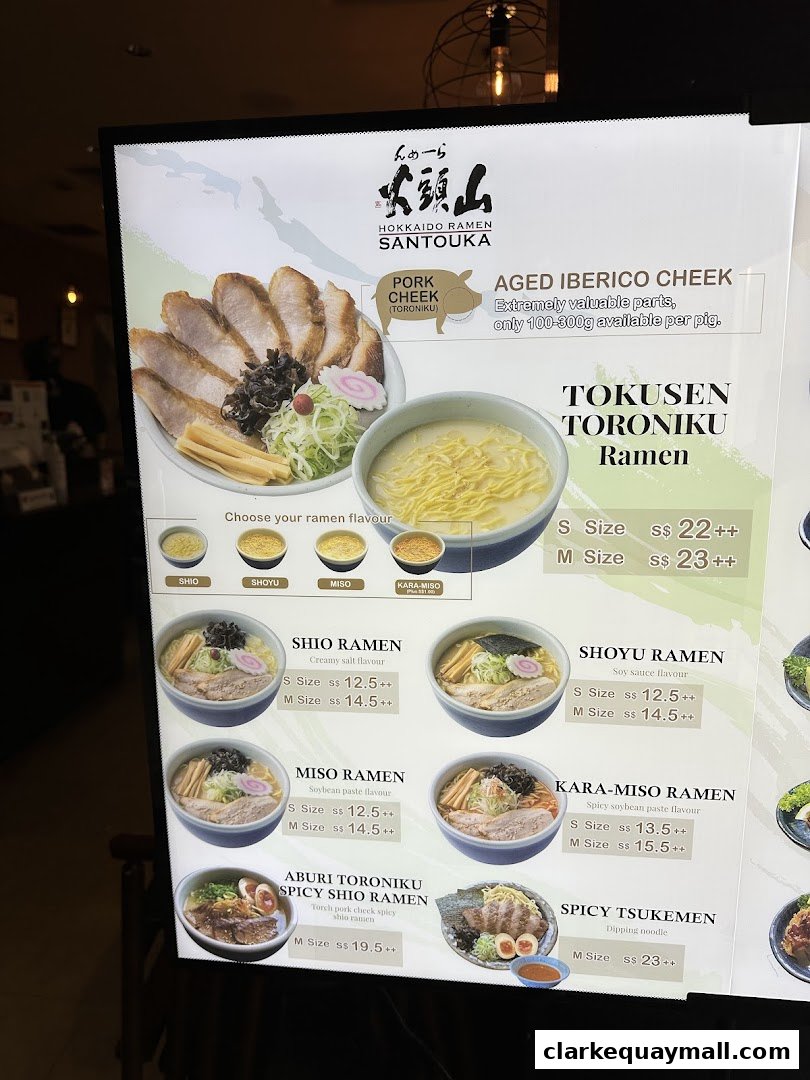 A menu board for Hokkaido Ramen Santouka, showcasing various ramen dishes and their prices.