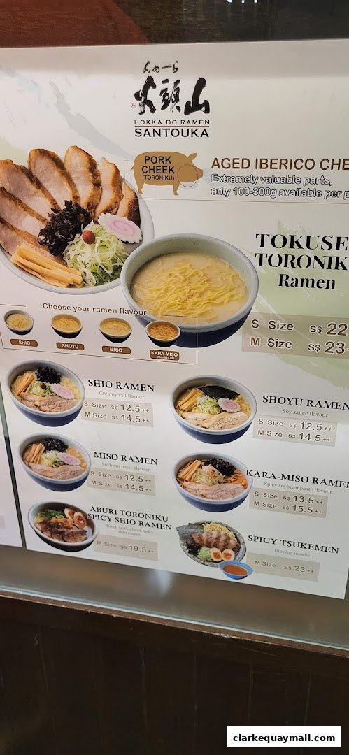A menu board showcasing various ramen dishes and their prices at Hokkaido Ramen Santouka.