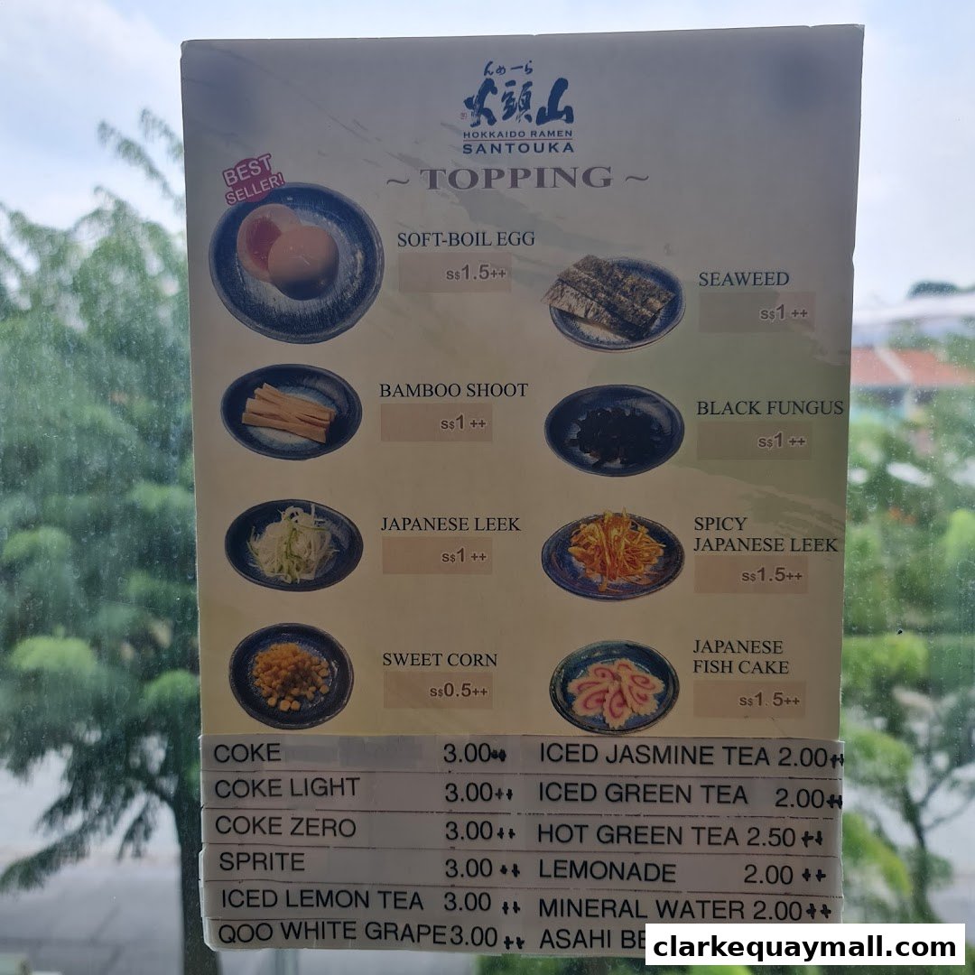 A menu board for Hokkaido Ramen Santouka, showcasing toppings and beverages with prices.