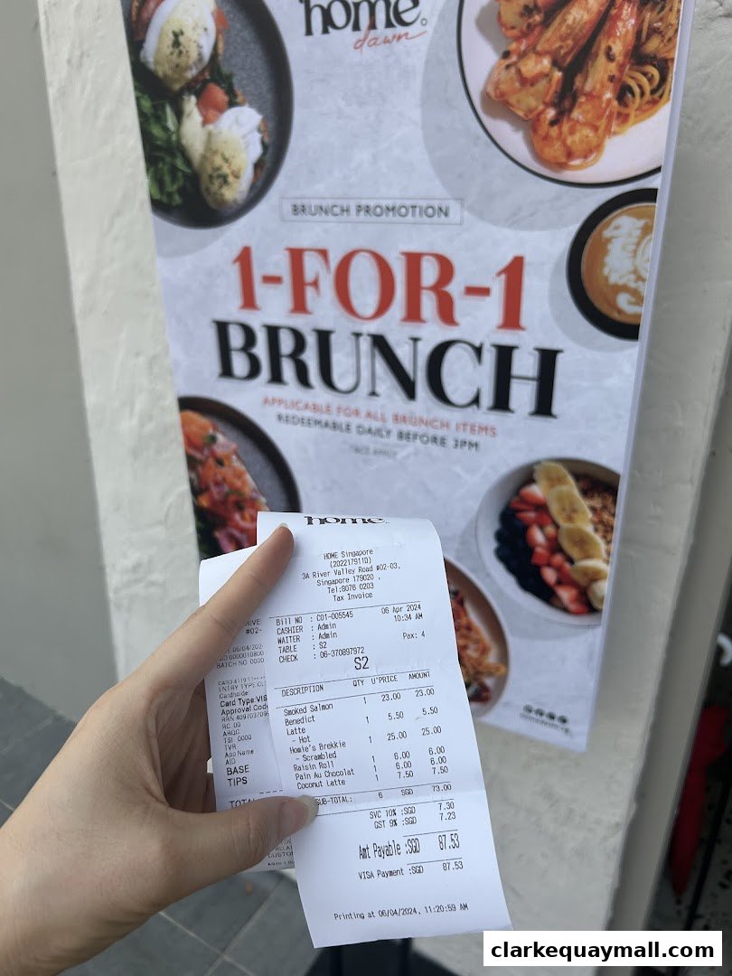 A hand holds a receipt from Home Dawn, showcasing a 1-for-1 brunch promotion.