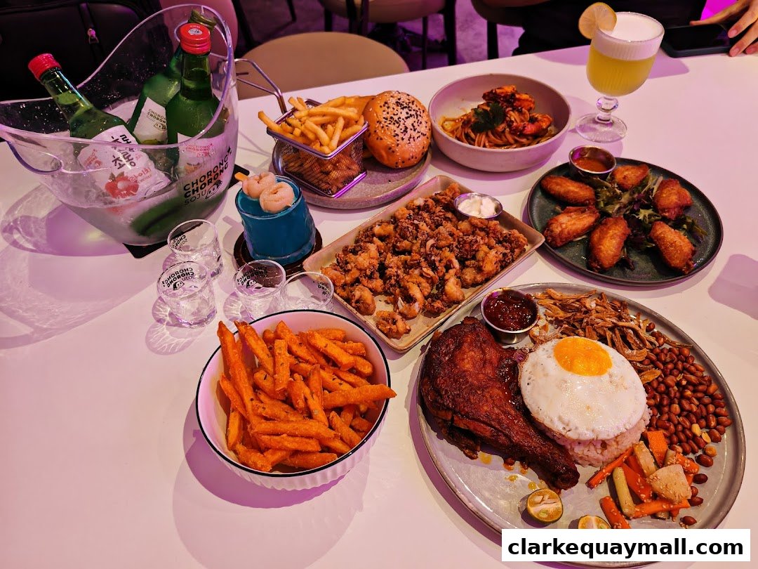 A table filled with various dishes, drinks, and bottles of soju, suggesting a lively dining experience.