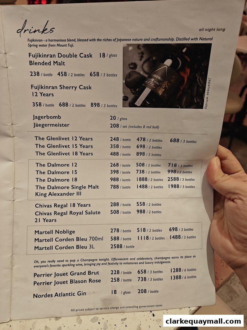 A menu featuring a selection of whiskies, cognacs, champagne, and gin with prices.