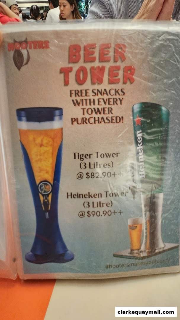 A menu item from Hooters featuring beer towers with free snacks.