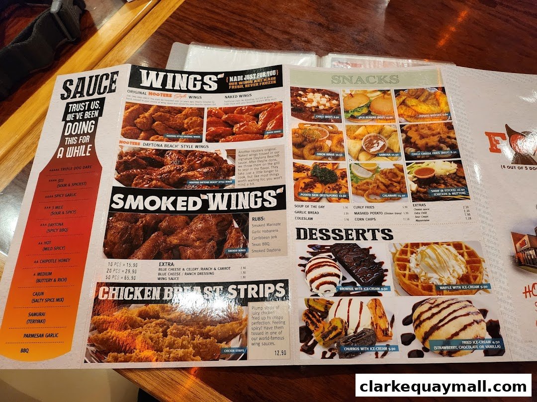 A Hooters menu featuring wings, snacks, desserts, and sauces with prices.