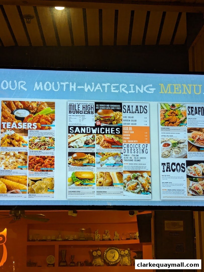 A menu board displaying various food items like burgers, sandwiches, salads, seafood, and tacos.