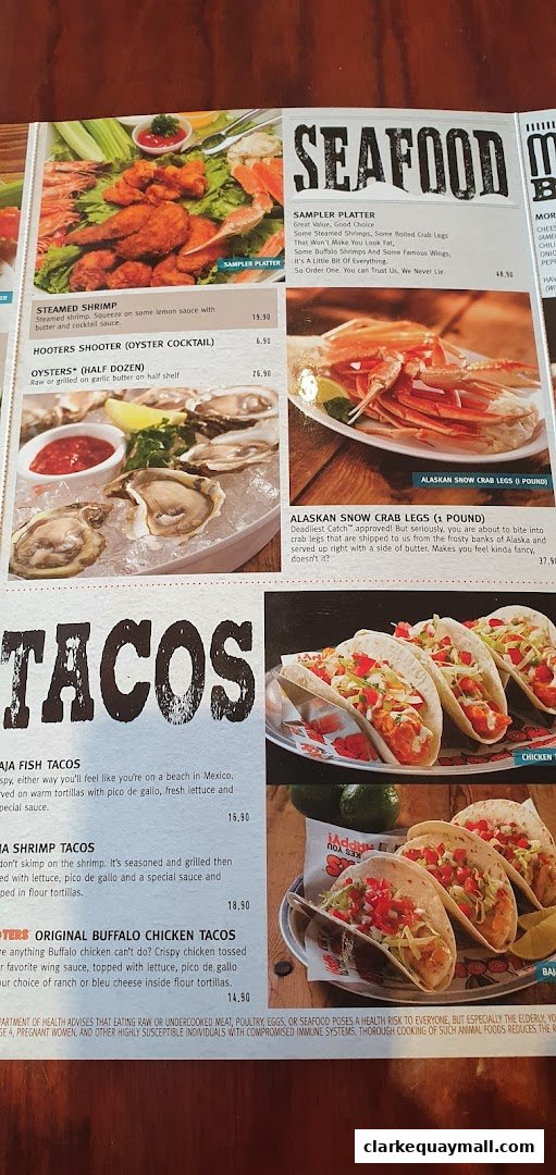 A Hooters menu featuring seafood and taco dishes with enticing images and descriptions.