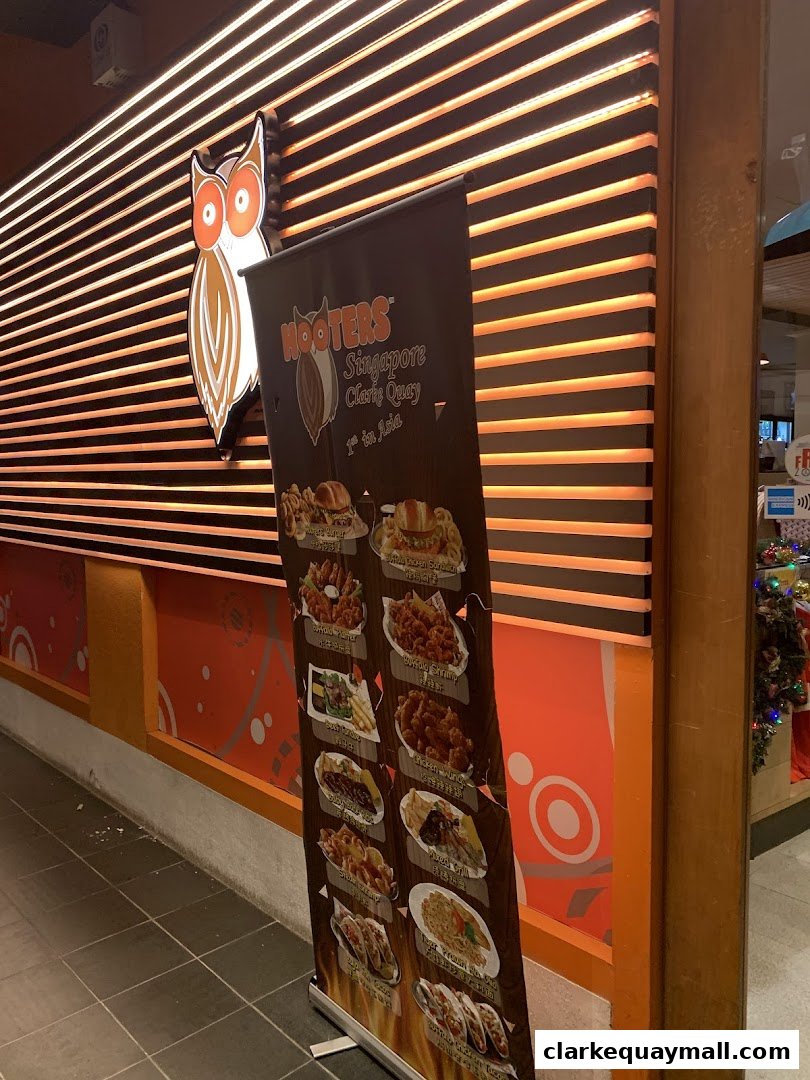 A Hooters Singapore Clarke Quay promotional banner displays various food items.