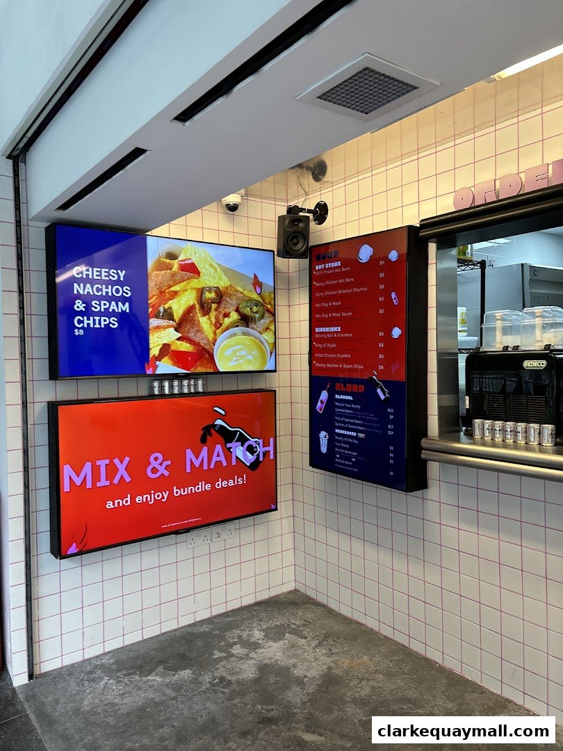 A digital menu board displays food items and prices, with a promotional screen for bundle deals.