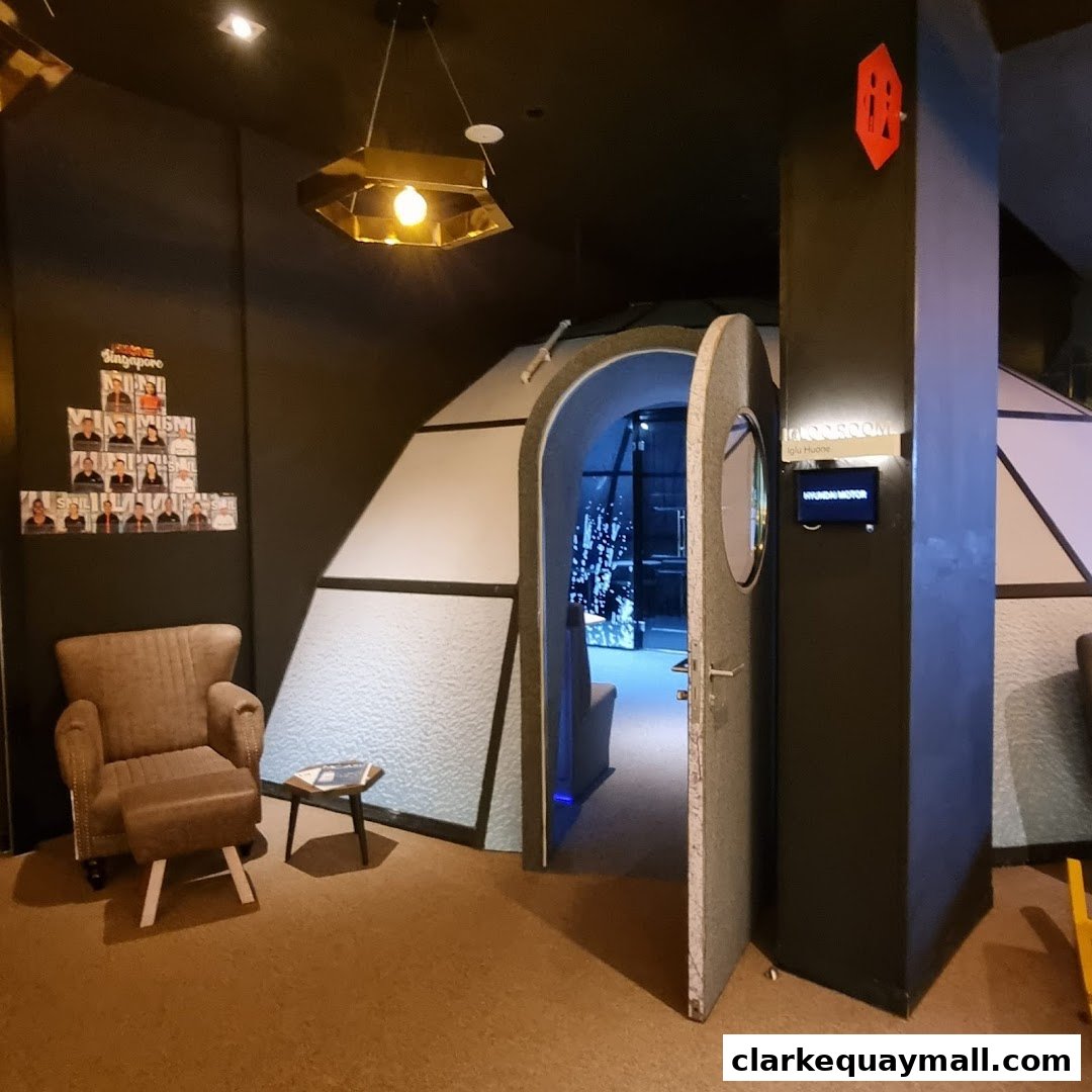Interior of a unique themed room with an open door, a chair, and a display of photos.