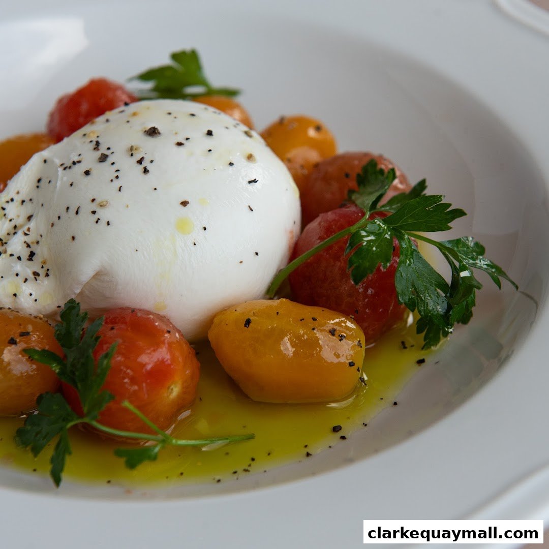 A close-up of creamy burrata cheese served with cherry tomatoes and fresh parsley.