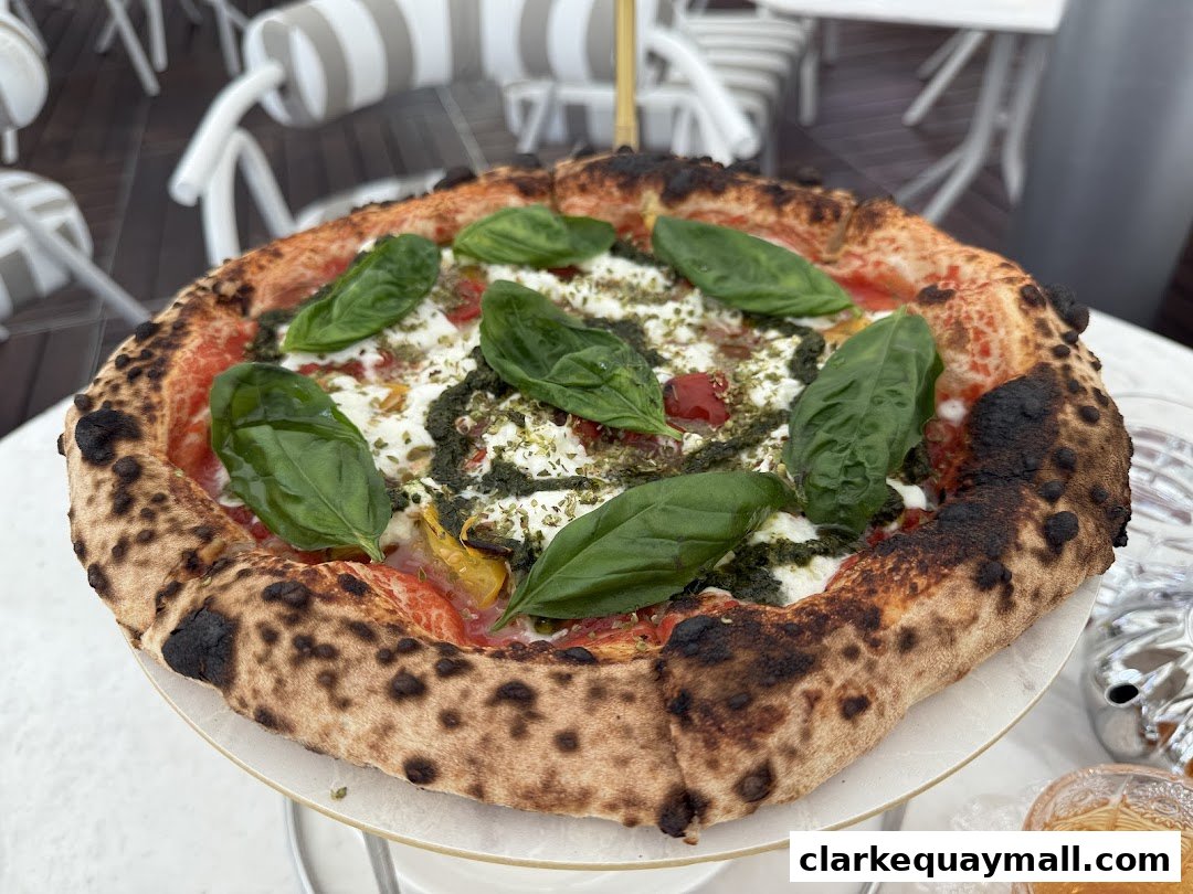 A delicious Neapolitan pizza with fresh basil, mozzarella, and a rich tomato sauce.