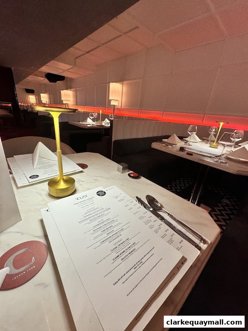 A table setting at IL CLAY restaurant with menus and cutlery.