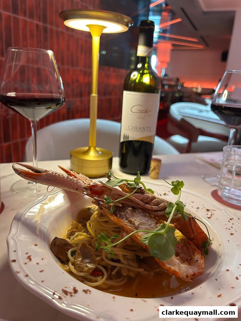 A plate of seafood pasta with a glass of red wine and a bottle of Chianti.