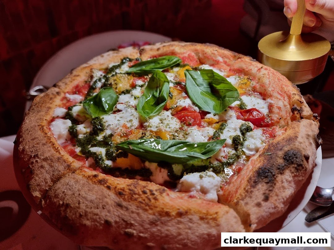 A delicious-looking pizza with fresh basil, tomatoes, and mozzarella cheese.