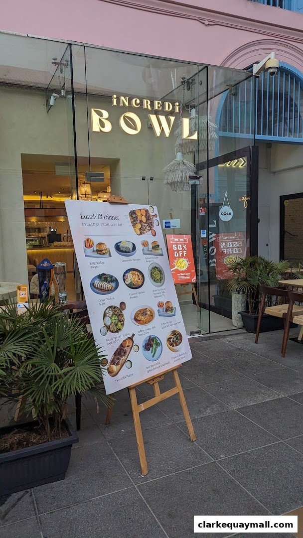 A menu board outside iNCREDi BOWL showcasing various lunch and dinner dishes.