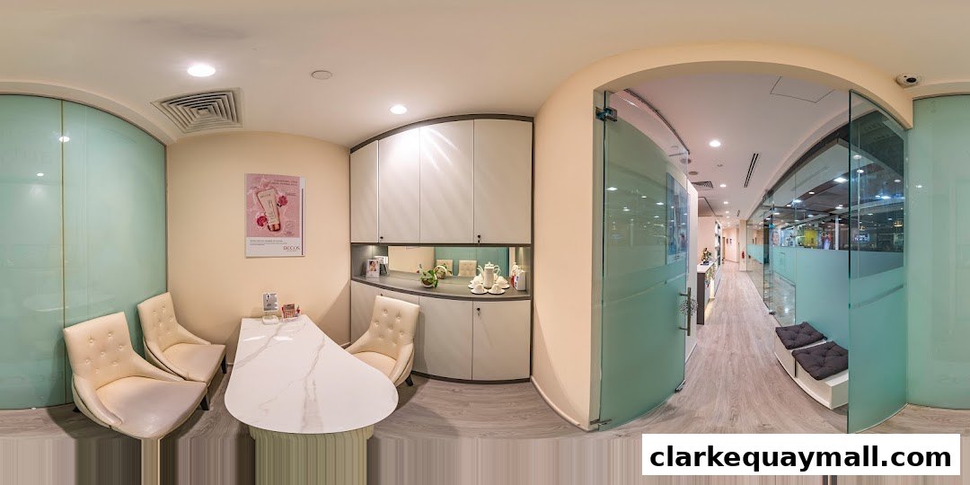 Interior view of a modern beauty salon with seating, reception desk, and treatment rooms.