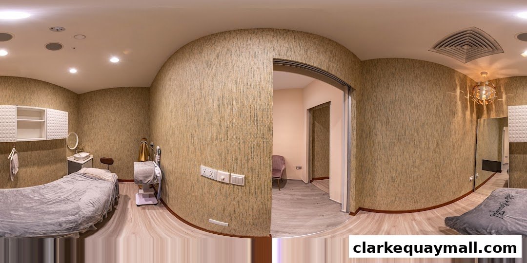 Interior view of a beauty treatment room with a bed, sink, and equipment.
