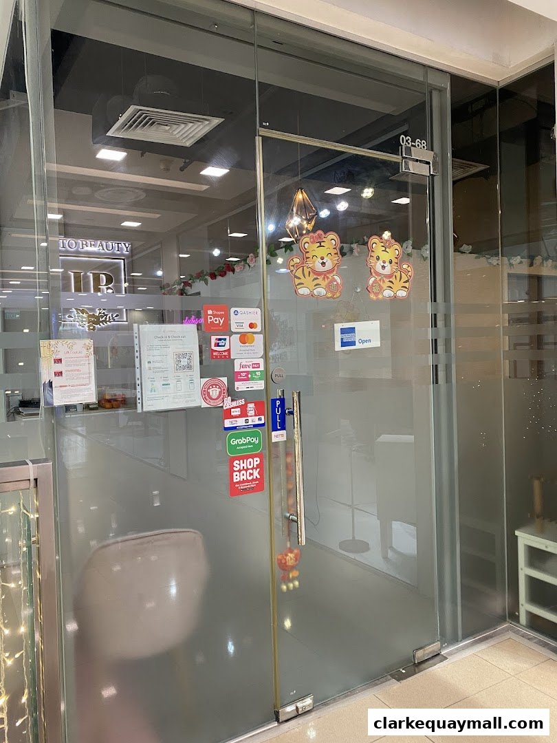 The entrance to 'Into Beauty' shop with payment method stickers and festive tiger decorations.
