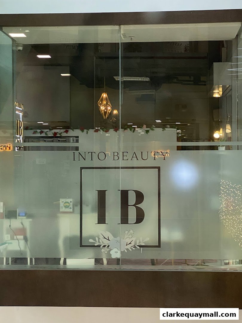 The entrance of the 'Into Beauty' shop with frosted glass and the 'IB' logo.
