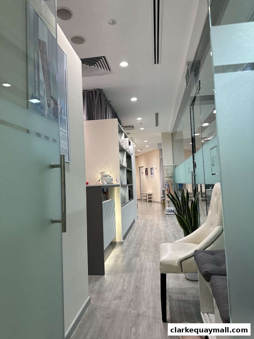 Interior view of a modern beauty salon with a reception desk and seating area.