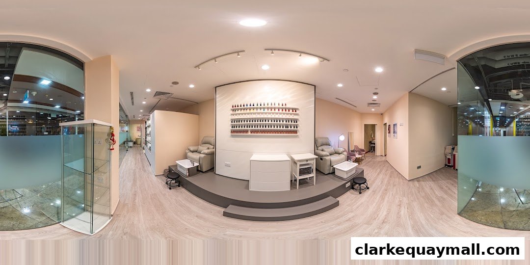 Interior view of a nail salon with pedicure chairs, nail polish display, and treatment stations.
