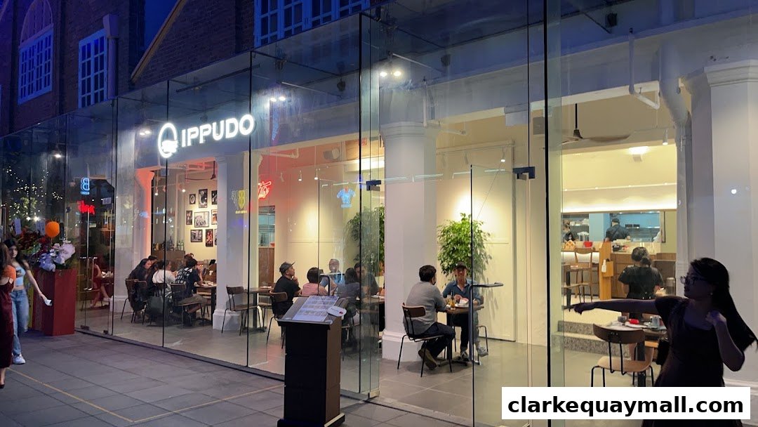 The exterior of Ippudo Clarke Quay restaurant with customers dining inside.