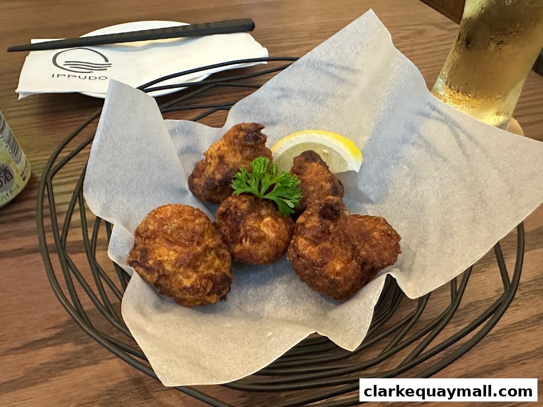 Crispy fried chicken pieces served with lemon and parsley in a basket.