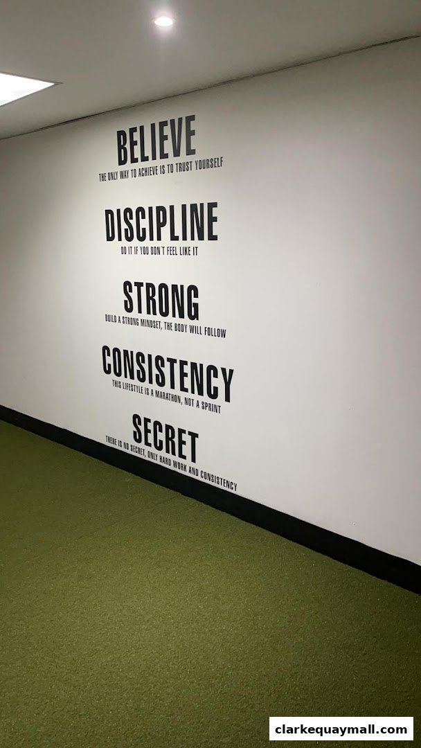 Wall with motivational fitness quotes in a gym setting.