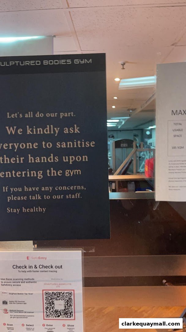 A sign at the entrance of Sculptured Bodies Gym requests visitors to sanitize their hands.
