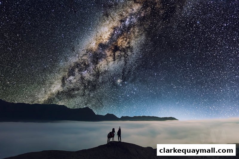 Two figures and a horse stand on a hilltop under a vast, starry sky with the Milky Way visible.