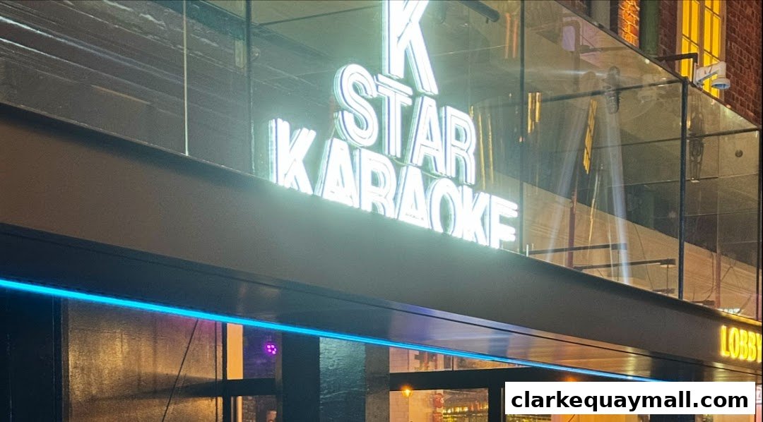 The illuminated sign for K.STAR KARAOKE is prominently displayed on the shop's facade.