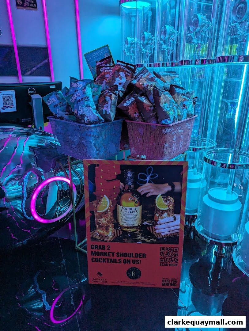 A display of snacks and a promotional sign for Monkey Shoulder cocktails.