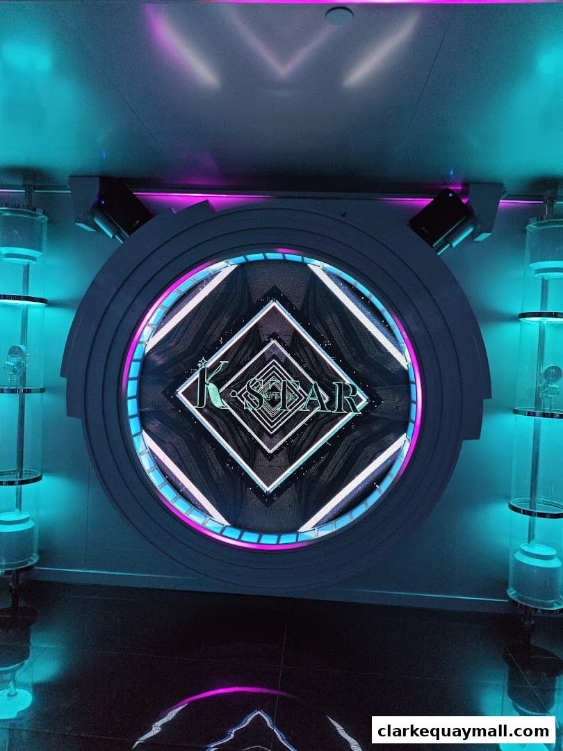 The K.STAR Clarke Quay logo is displayed on a circular, illuminated screen with neon accents.