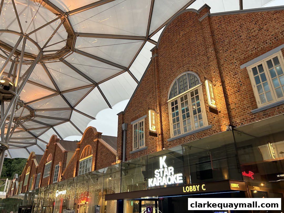 Exterior of K.STAR KARAOKE with illuminated signage and brick facade.