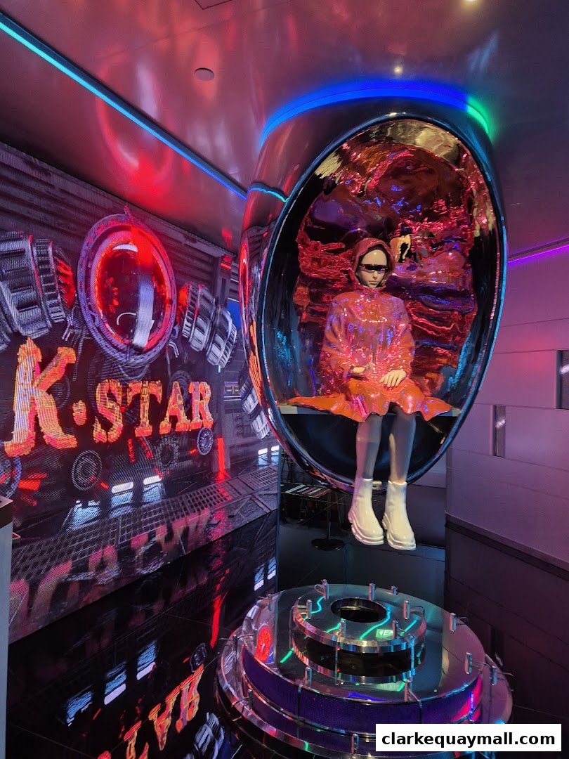 A futuristic display with a mannequin in a shiny outfit inside a pod.