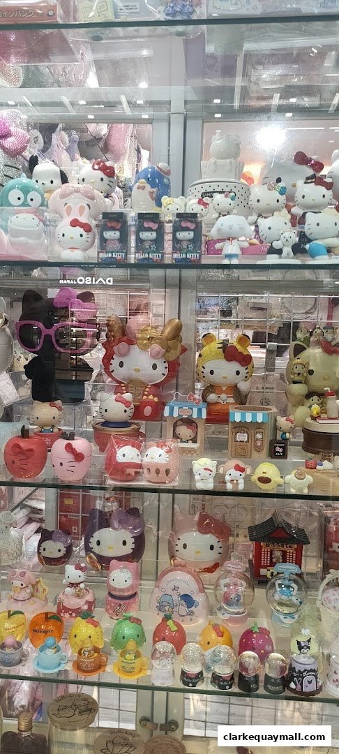 A display case filled with various Hello Kitty and Sanrio character merchandise, including figurines and snow globes.