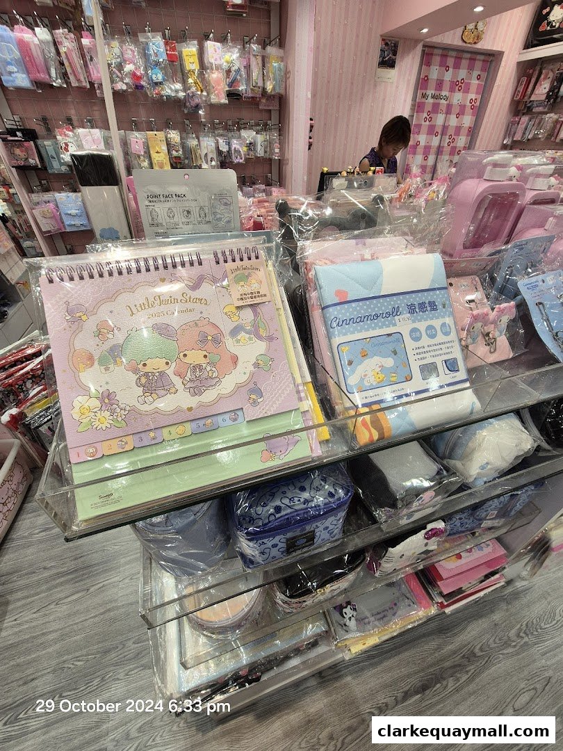 A retail shop interior displaying various cute stationery and gift items, including calendars and character-themed products.