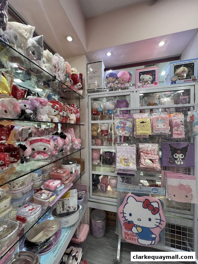 A shop interior filled with Hello Kitty and Sanrio character merchandise, including plush toys and storage containers.