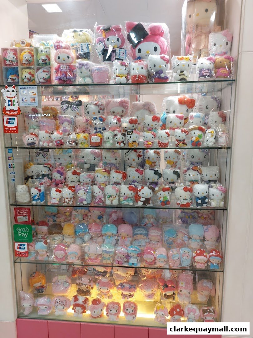 A display case filled with various Hello Kitty and My Melody plush toys and character merchandise.