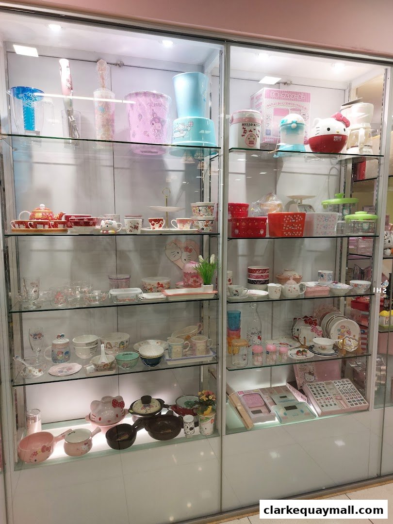 A display cabinet filled with various kitchenware and home goods, many featuring Hello Kitty.
